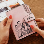 Carteira personalizada feminina rosa sendo segurada nas mãos, com foto de família impressa e nome personalizado na aba.